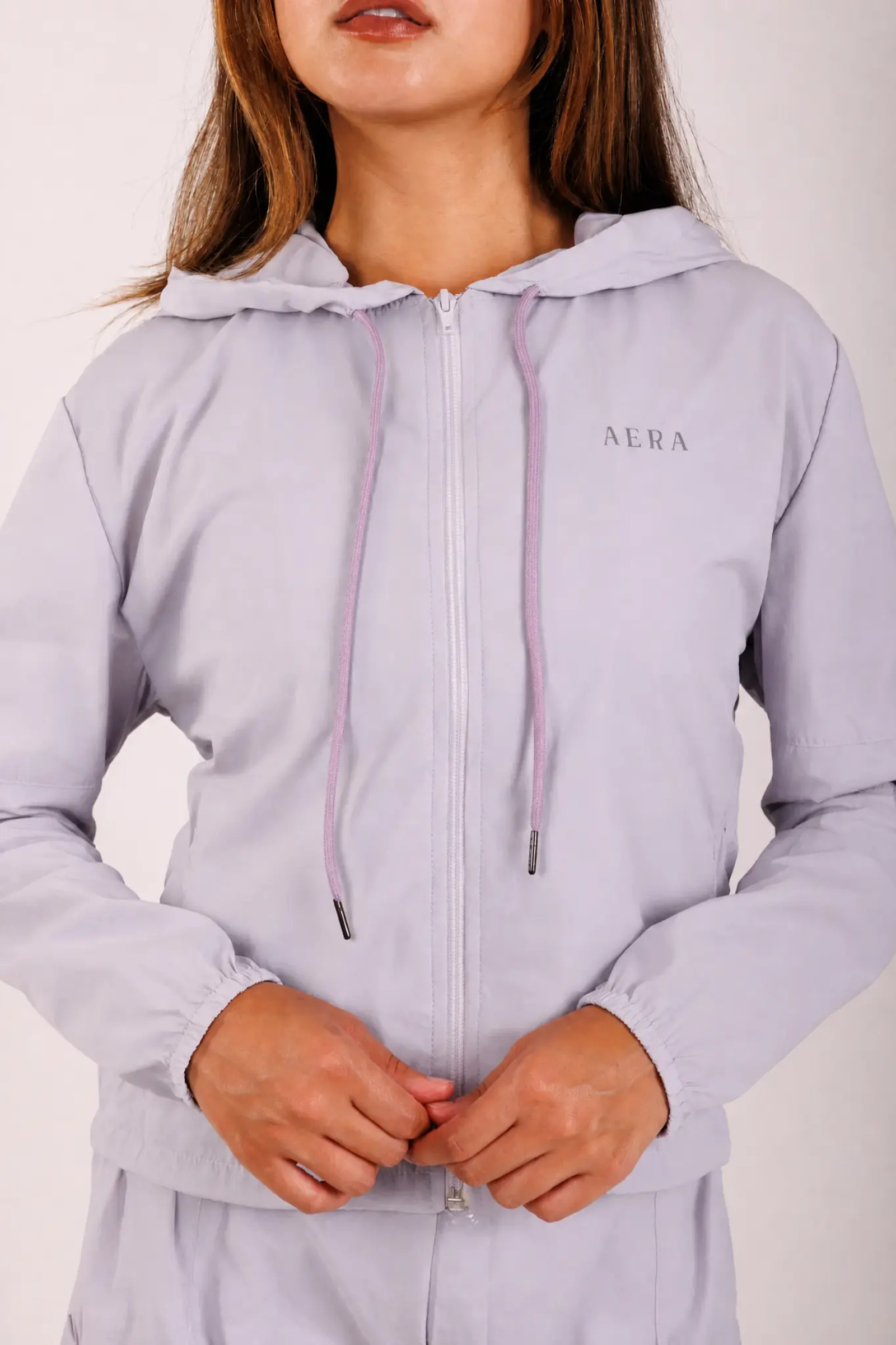 Detail of the light blue AERA sports bra with the logo in the center